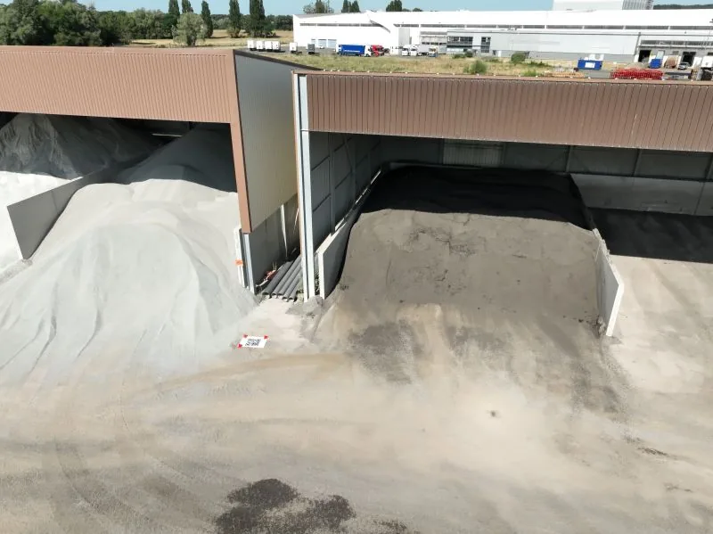 Aerial view of a quarry's storage areas and truck access during a drone volume survey — Dronexperts