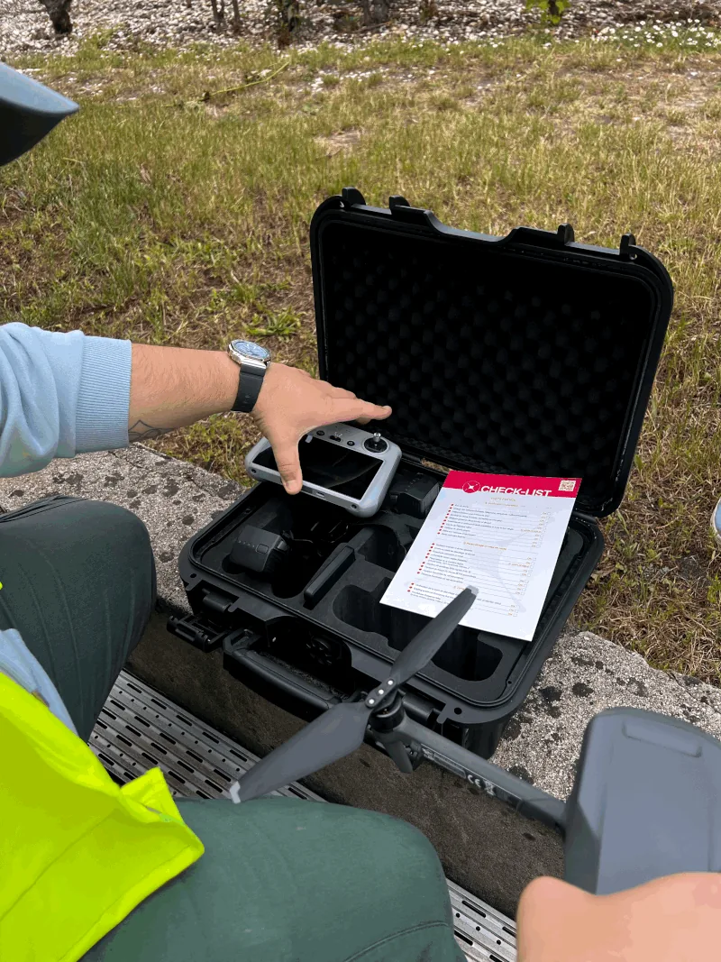 Pre-flight checklist and open drone transport case during the hands-on session — Dronexperts drone pilot training